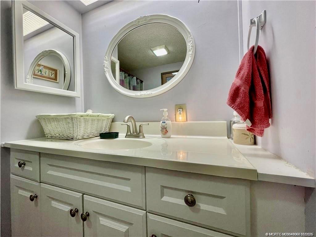 16236 Southwest Three Wood Way Indiantown, FL 34956 - Photo 18 of 26 a bathroom with a sink and a mirror