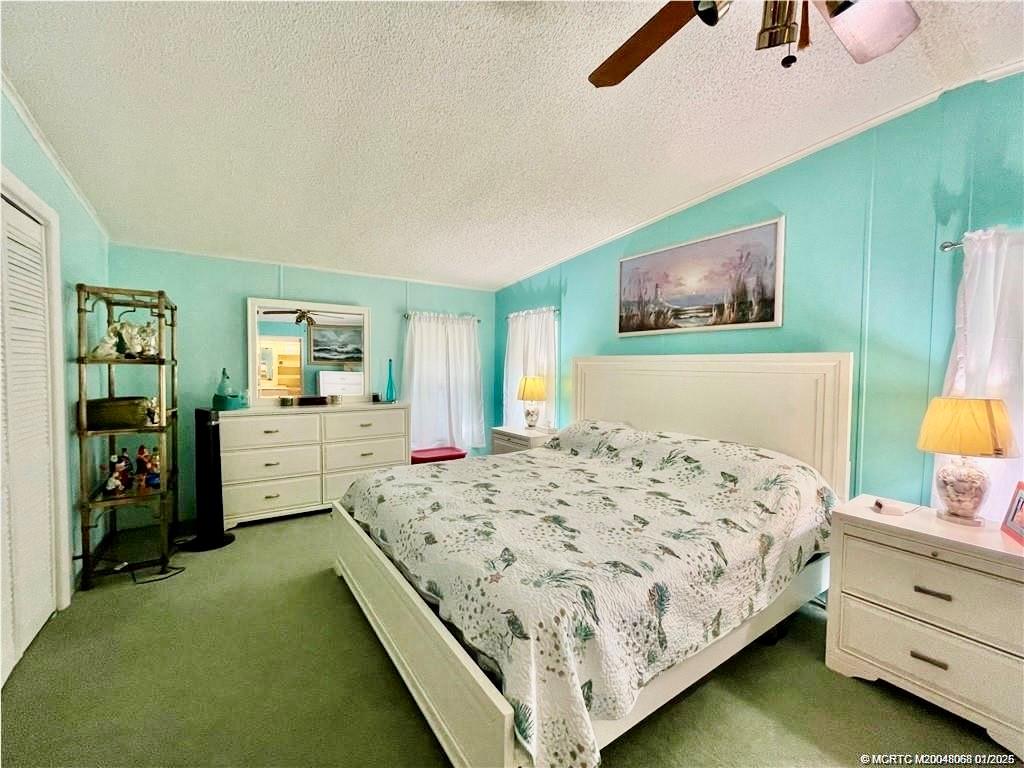 16236 Southwest Three Wood Way Indiantown, FL 34956 - Photo 6 of 26 a bedroom with a bed and a view of kitchen