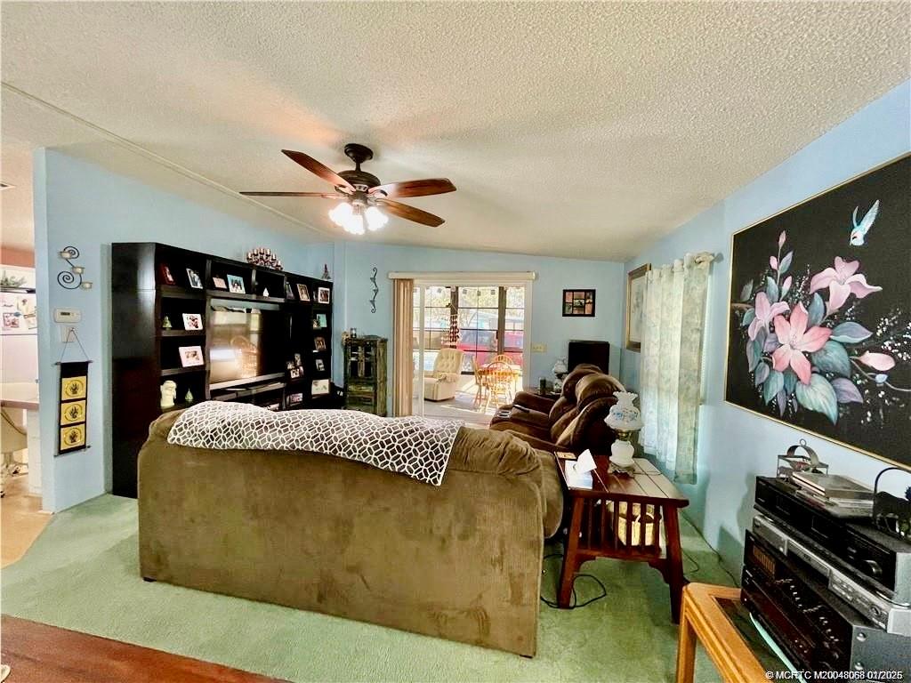 16236 Southwest Three Wood Way Indiantown, FL 34956 - Photo 10 of 26 a living room with furniture and a flat screen tv