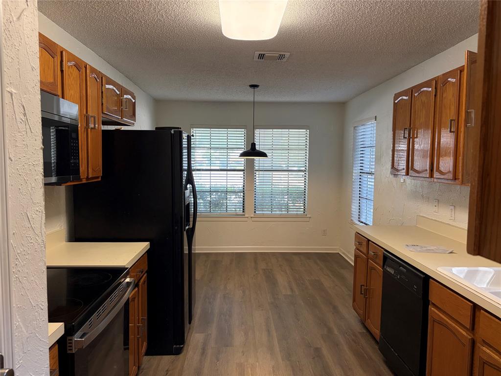 112 Cinnamon Lane Euless, TX 76039 - Photo 4 of 12 a kitchen with stainless steel appliances granite countertop a refrigerator a stove and a refrigerator