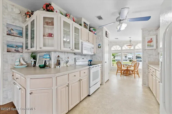a kitchen with counter top space and wooden cabinets