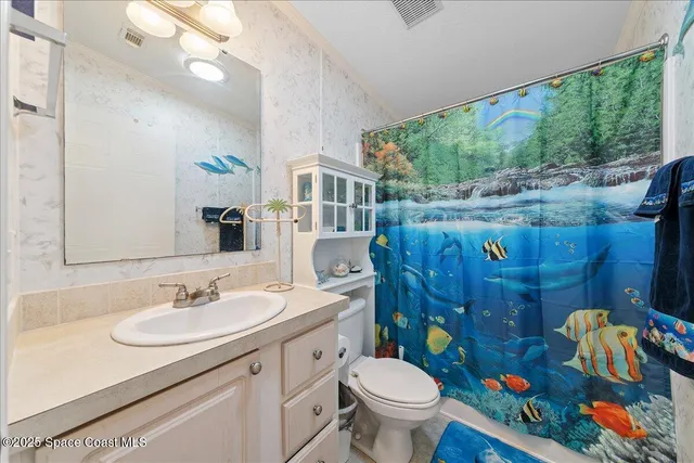 a bathroom with a sink toilet and garden view