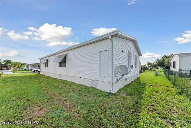 a view of a backyard with plants and a garden