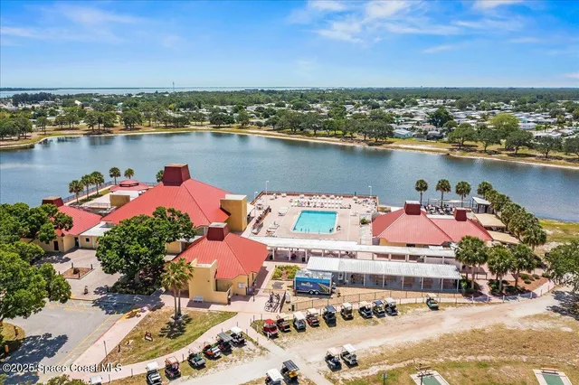 an aerial view of a houses with outdoor space lake view and mountain view