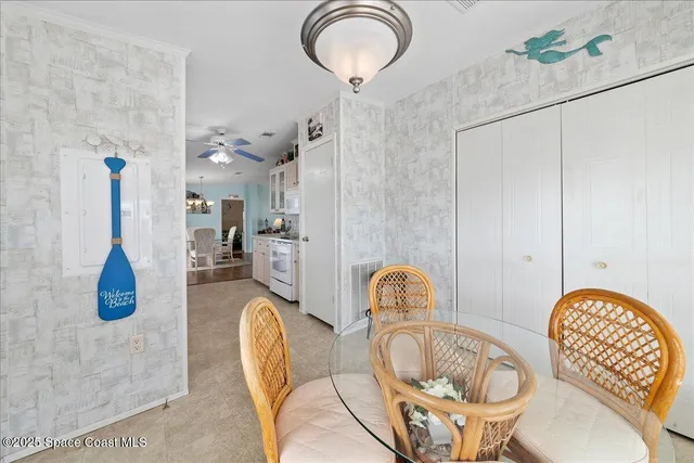 a dining room with furniture and a chandelier