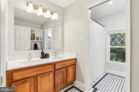 a bathroom with a sink double vanity and a mirror