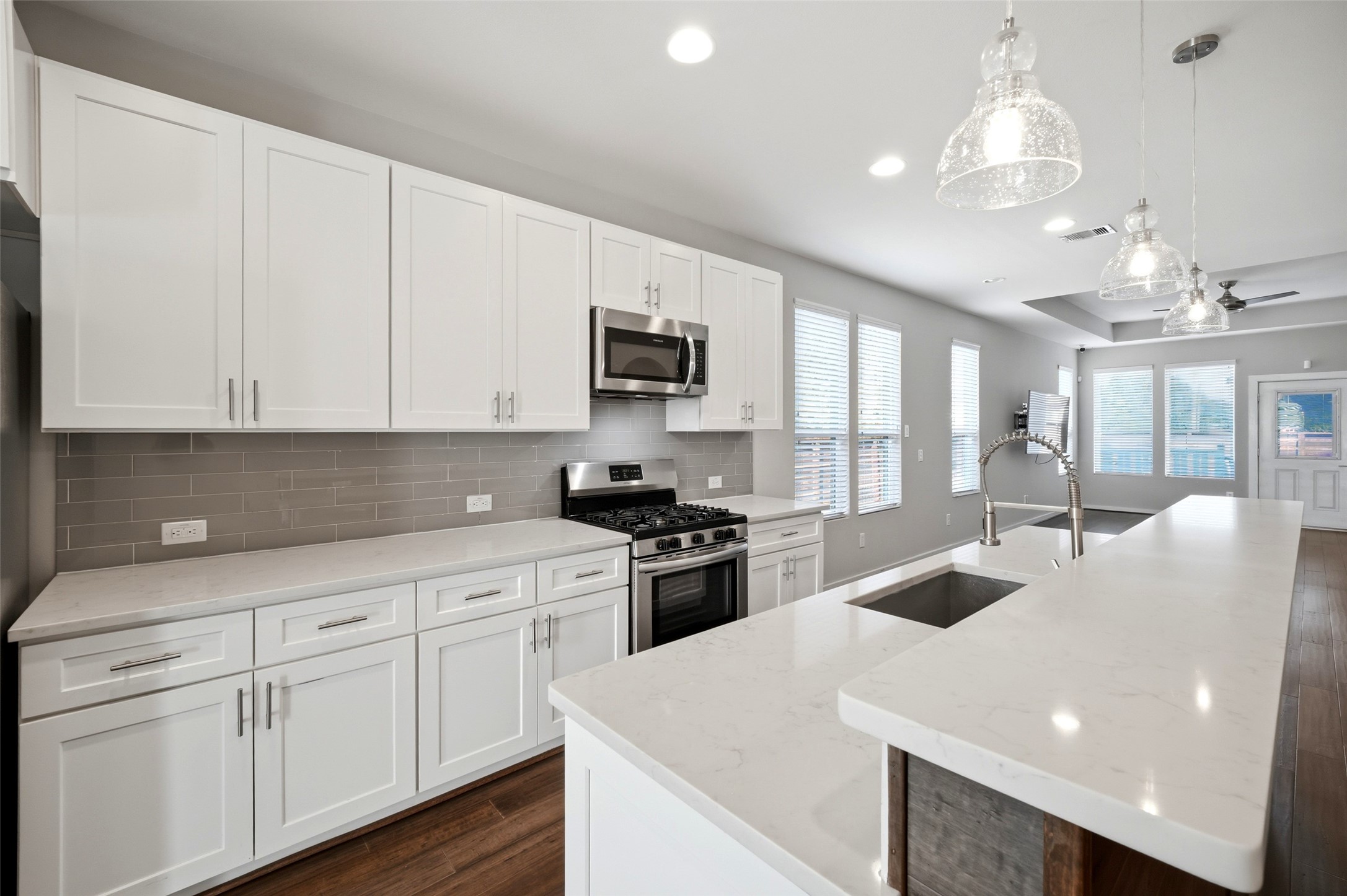 605 Dumble Street Houston, TX 77023 - Photo 19 of 44 a kitchen with sink a microwave and cabinets