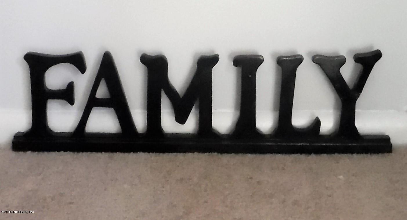10244 Pine Breeze Road South Jacksonville, FL 32257 - Photo 11 of 27 a black white and white kitchen with a black and white wooden floor