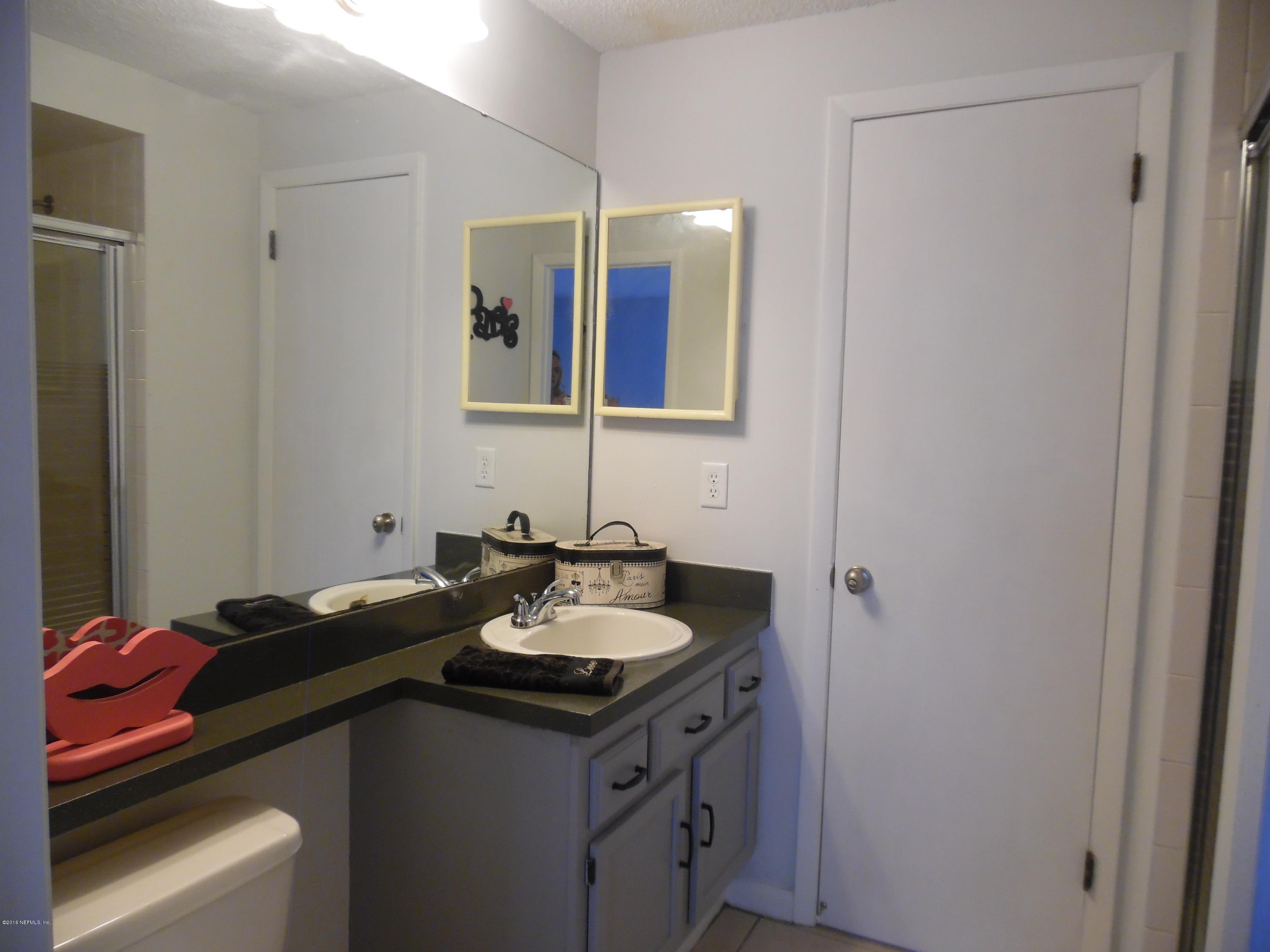 10244 Pine Breeze Road South Jacksonville, FL 32257 - Photo 13 of 27 a bathroom with a sink and a mirror