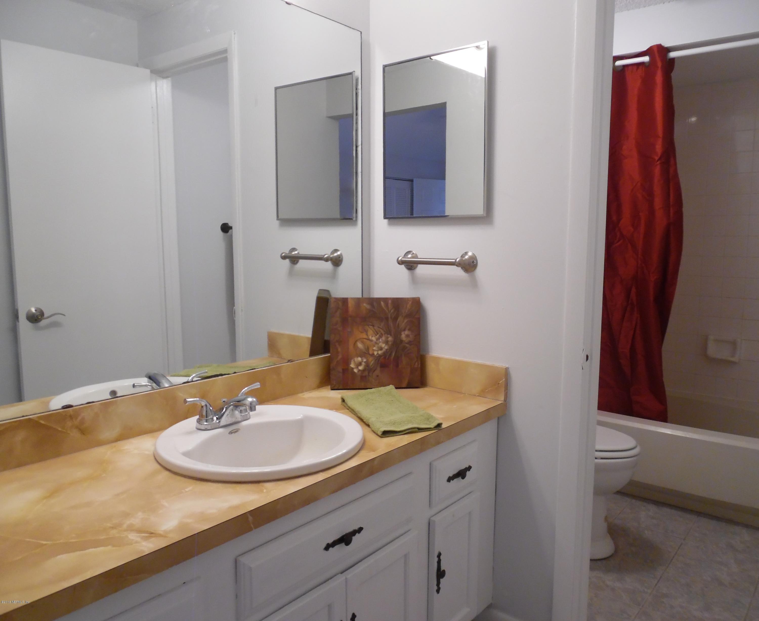 10244 Pine Breeze Road South Jacksonville, FL 32257 - Photo 17 of 27 a bathroom with a sink and a mirror