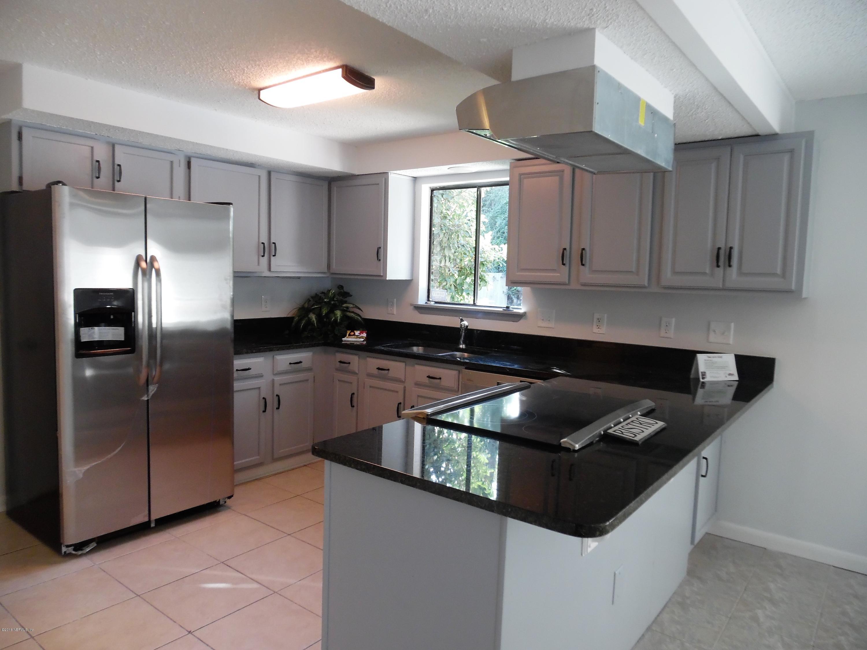 10244 Pine Breeze Road South Jacksonville, FL 32257 - Photo 2 of 27 a kitchen with granite countertop a sink a counter top space cabinets and stainless steel appliances