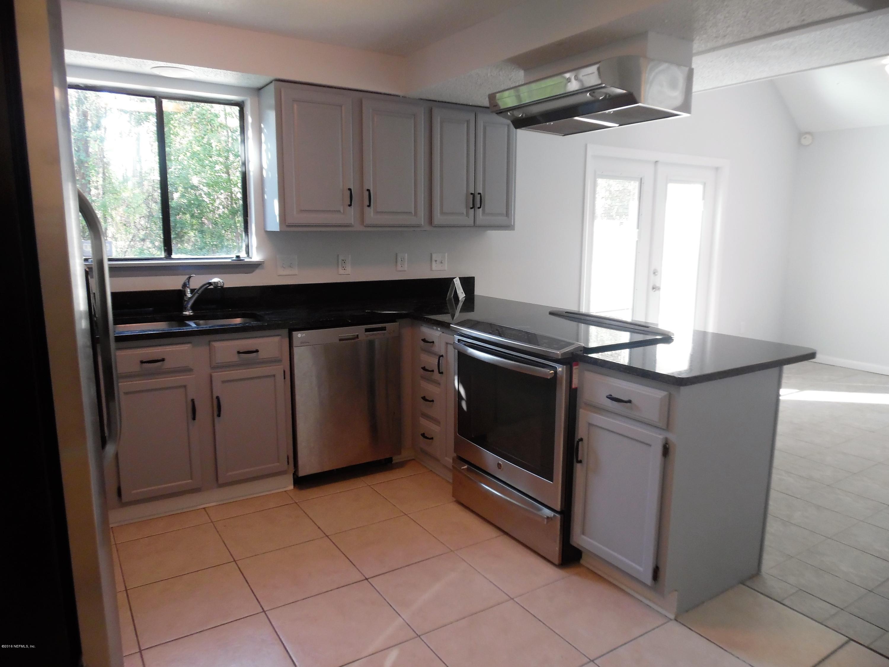 10244 Pine Breeze Road South Jacksonville, FL 32257 - Photo 3 of 27 a kitchen with stainless steel appliances granite countertop a stove a sink and a microwave