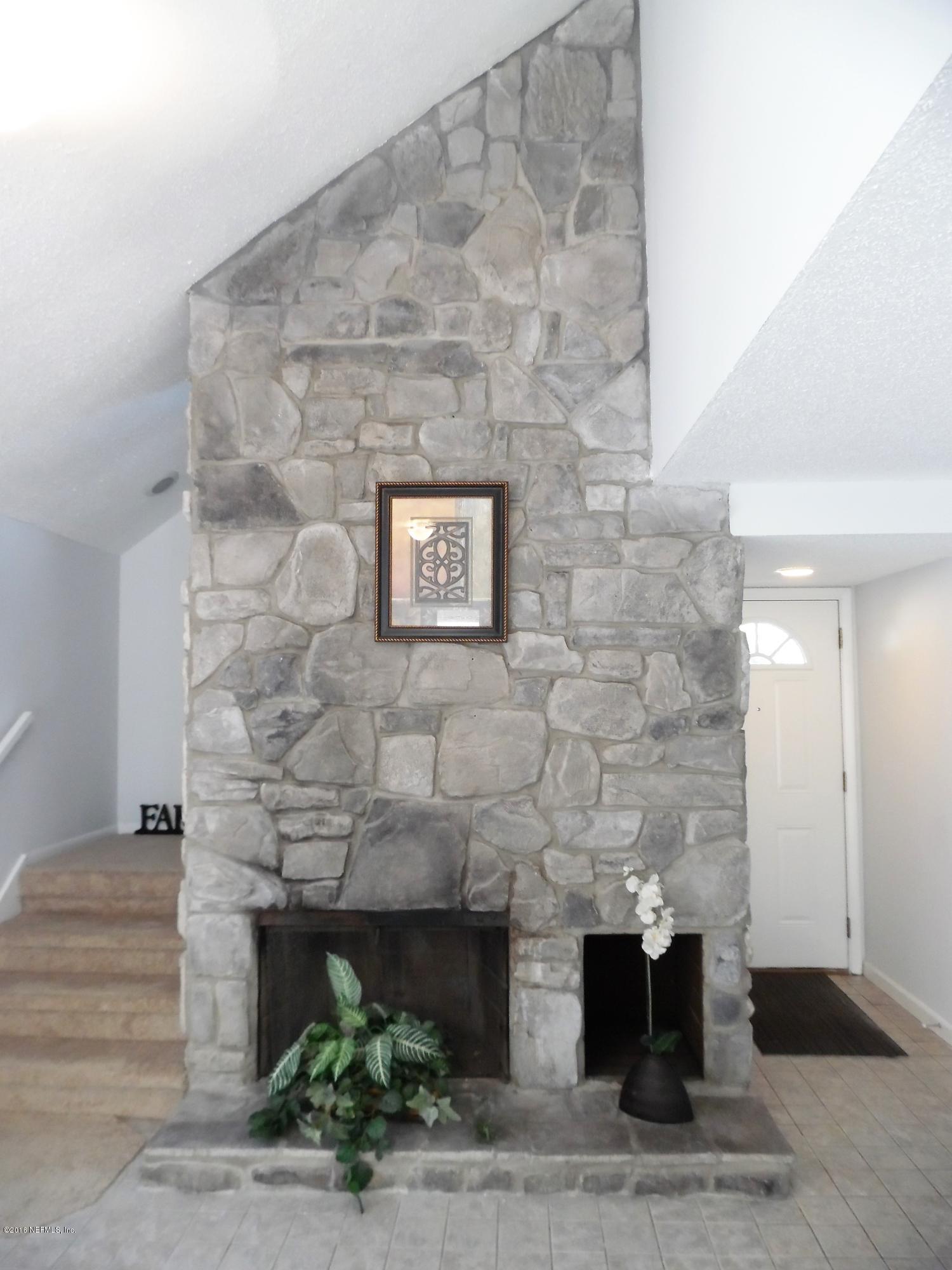 10244 Pine Breeze Road South Jacksonville, FL 32257 - Photo 8 of 27 a front view of a fireplace with potted plant