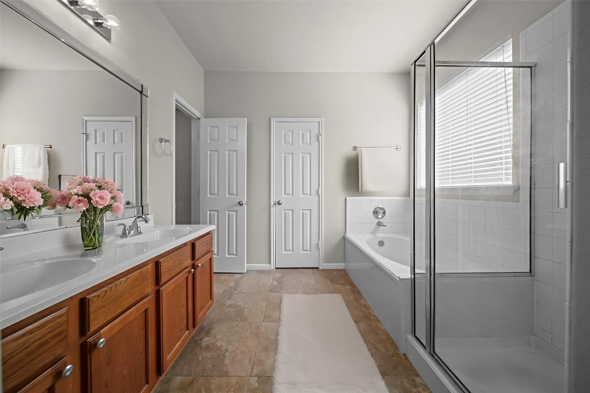 6047 Northcrest Village Way Spring, TX 77388 - Photo 15 of 30 a bathroom with a double vanity sink mirror and shower
