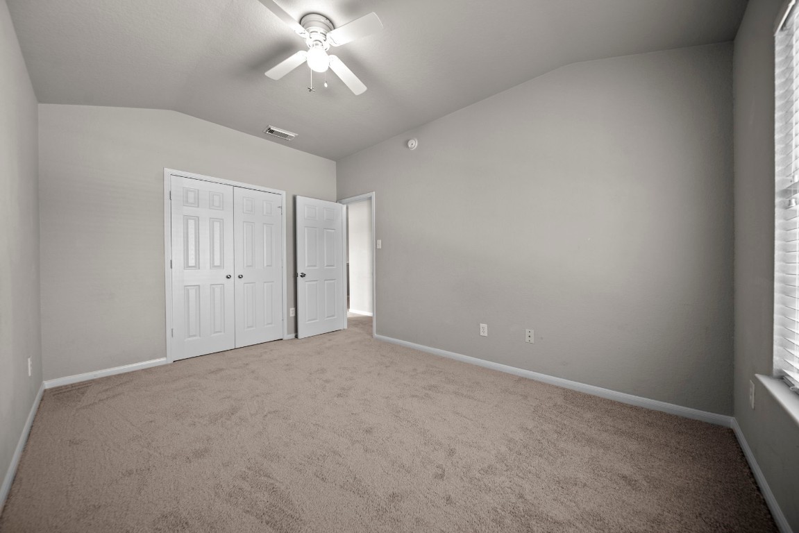 6047 Northcrest Village Way Spring, TX 77388 - Photo 20 of 30 en empty room with windows and fan