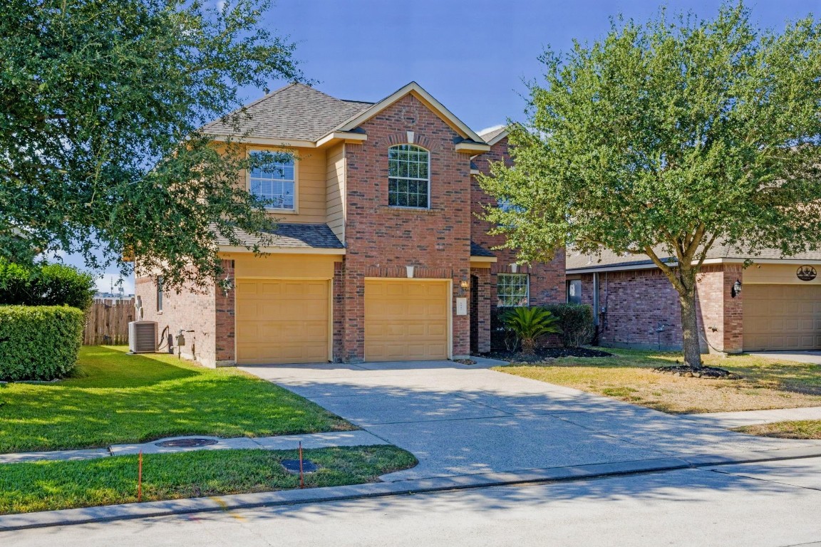 6047 Northcrest Village Way Spring, TX 77388 - Photo 2 of 30 a view of a house with a swimming pool and a yard