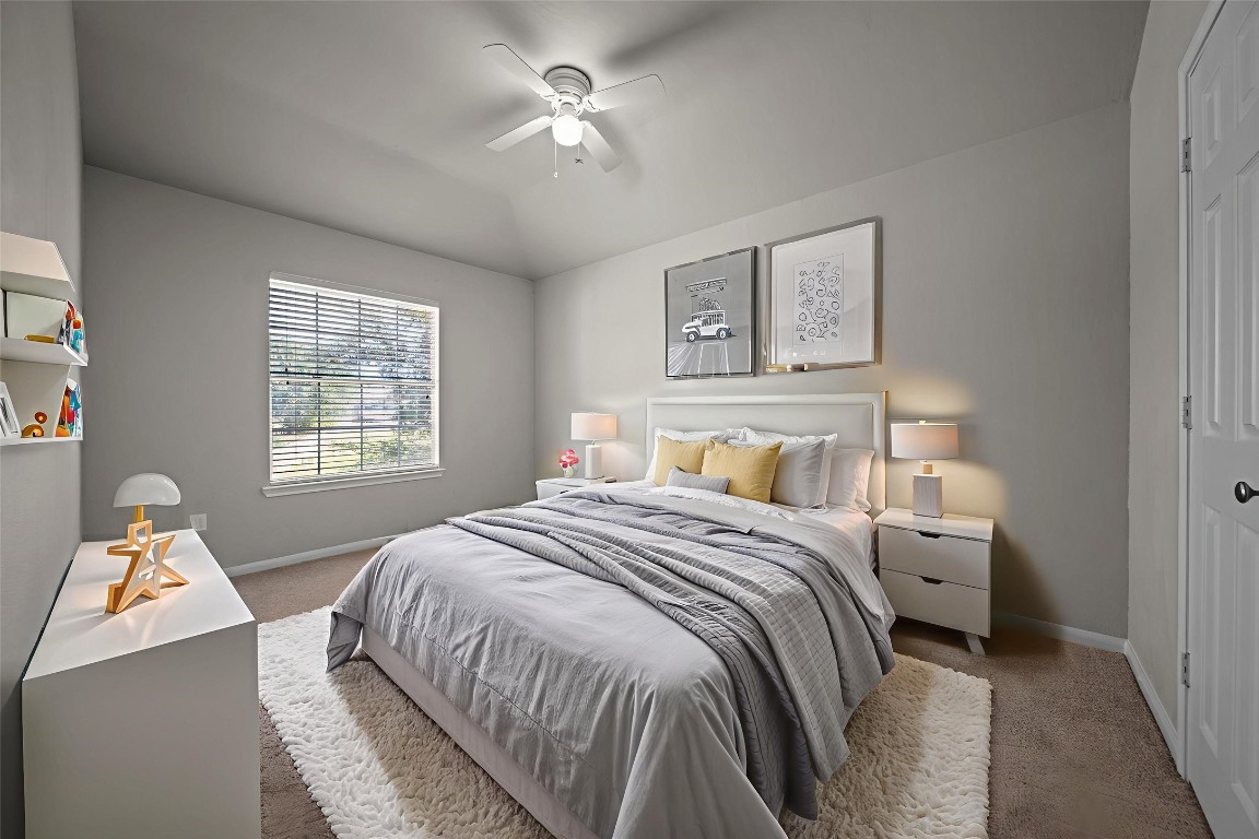 6047 Northcrest Village Way Spring, TX 77388 - Photo 21 of 30 a bedroom with a bed and a chandelier