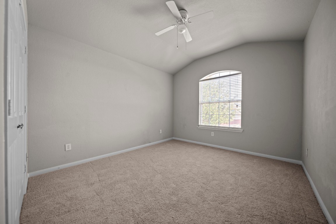6047 Northcrest Village Way Spring, TX 77388 - Photo 23 of 30 an empty room with a window and ceiling fan