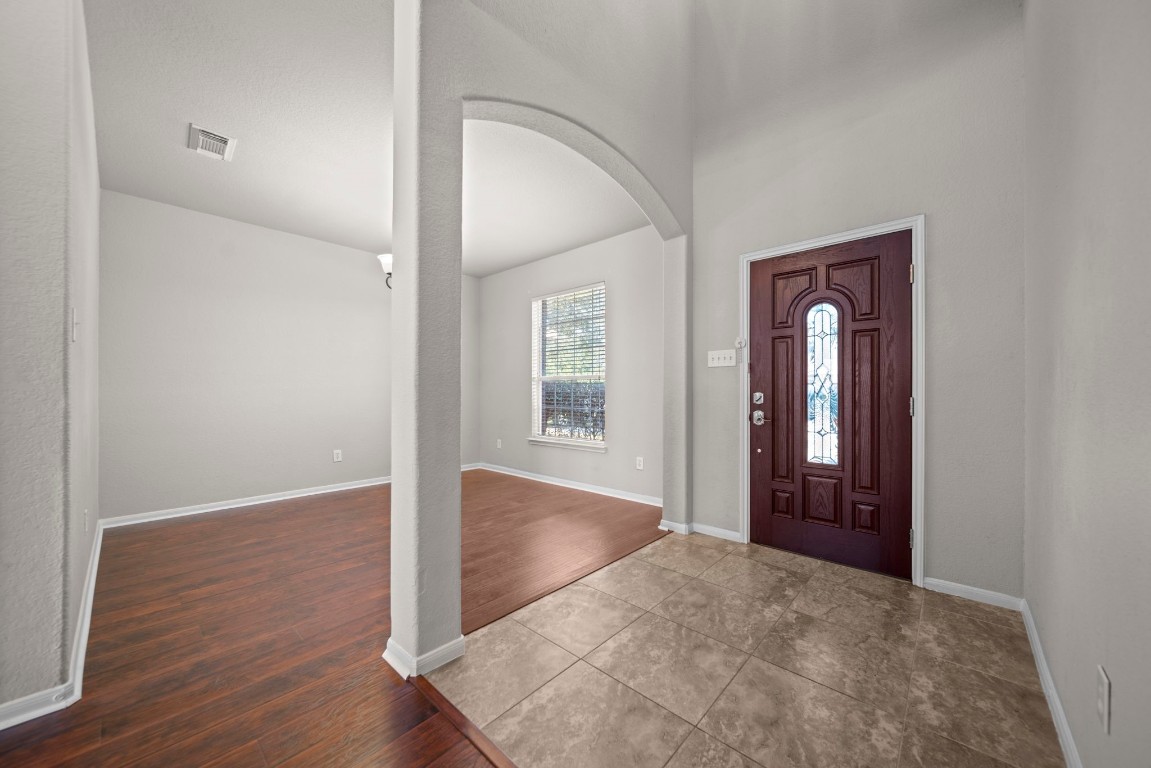 6047 Northcrest Village Way Spring, TX 77388 - Photo 3 of 30 an empty room with wooden floor and windows