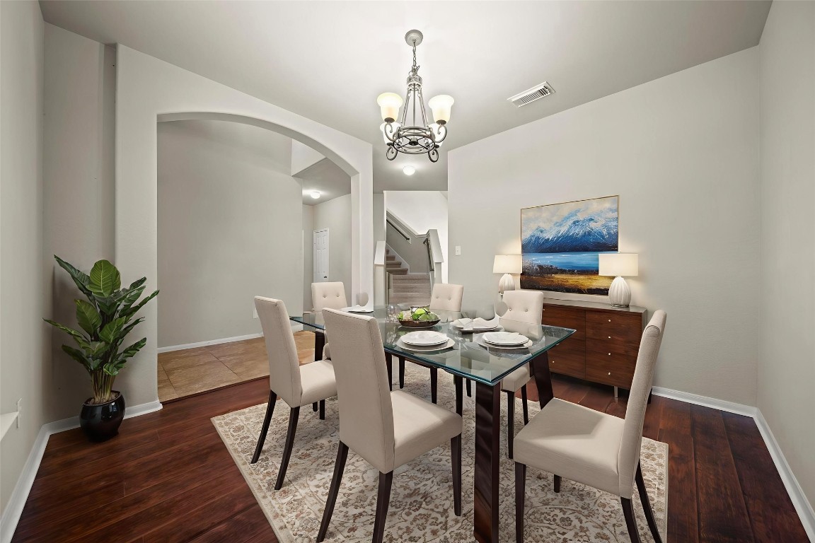 6047 Northcrest Village Way Spring, TX 77388 - Photo 4 of 30 a view of a dining room with furniture wooden floor and chandelier