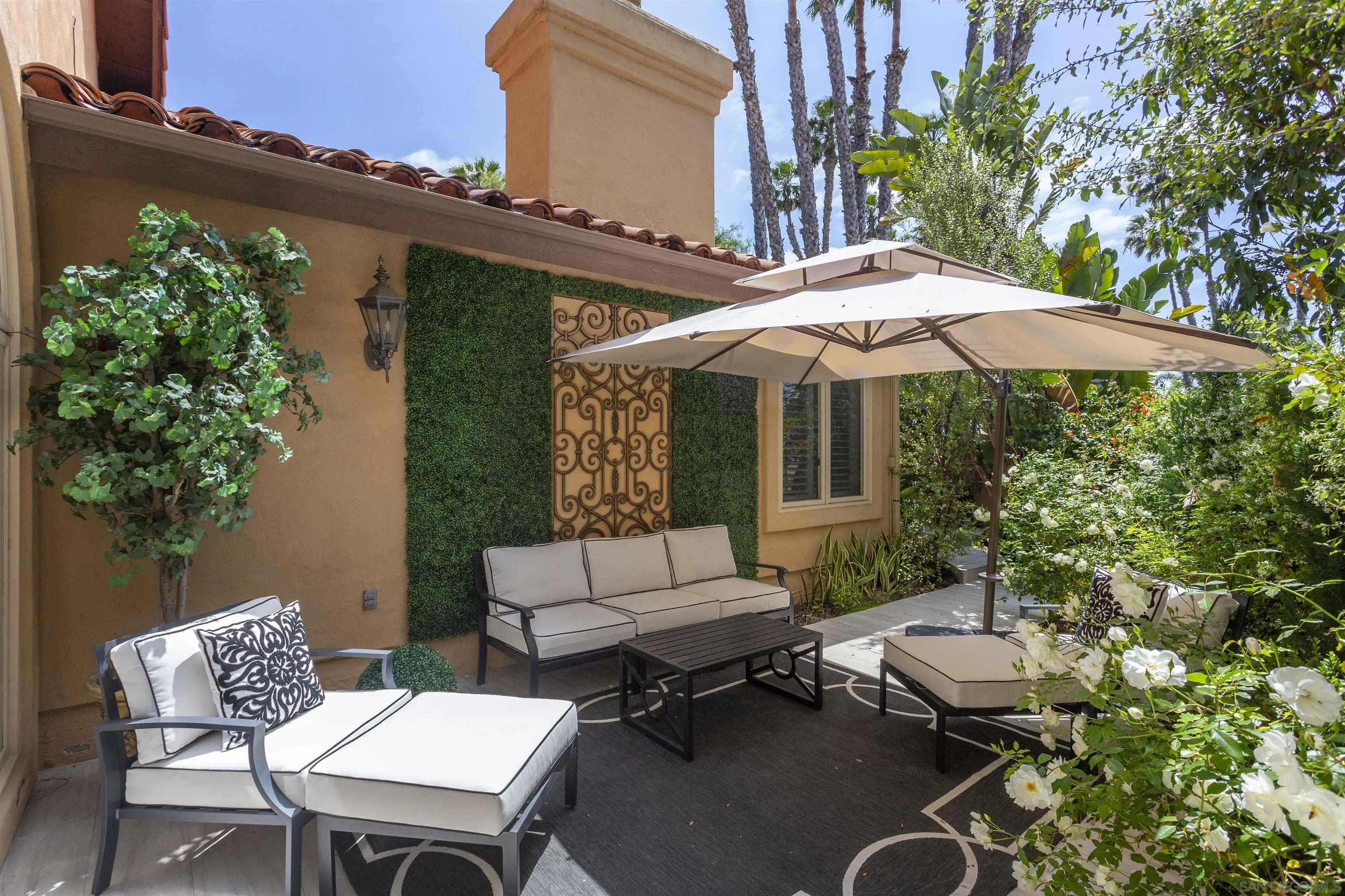 15448 Pimlico Corte Rancho Santa Fe, CA 92067 - Photo 5 of 31 a patio with a table and chairs under an umbrella