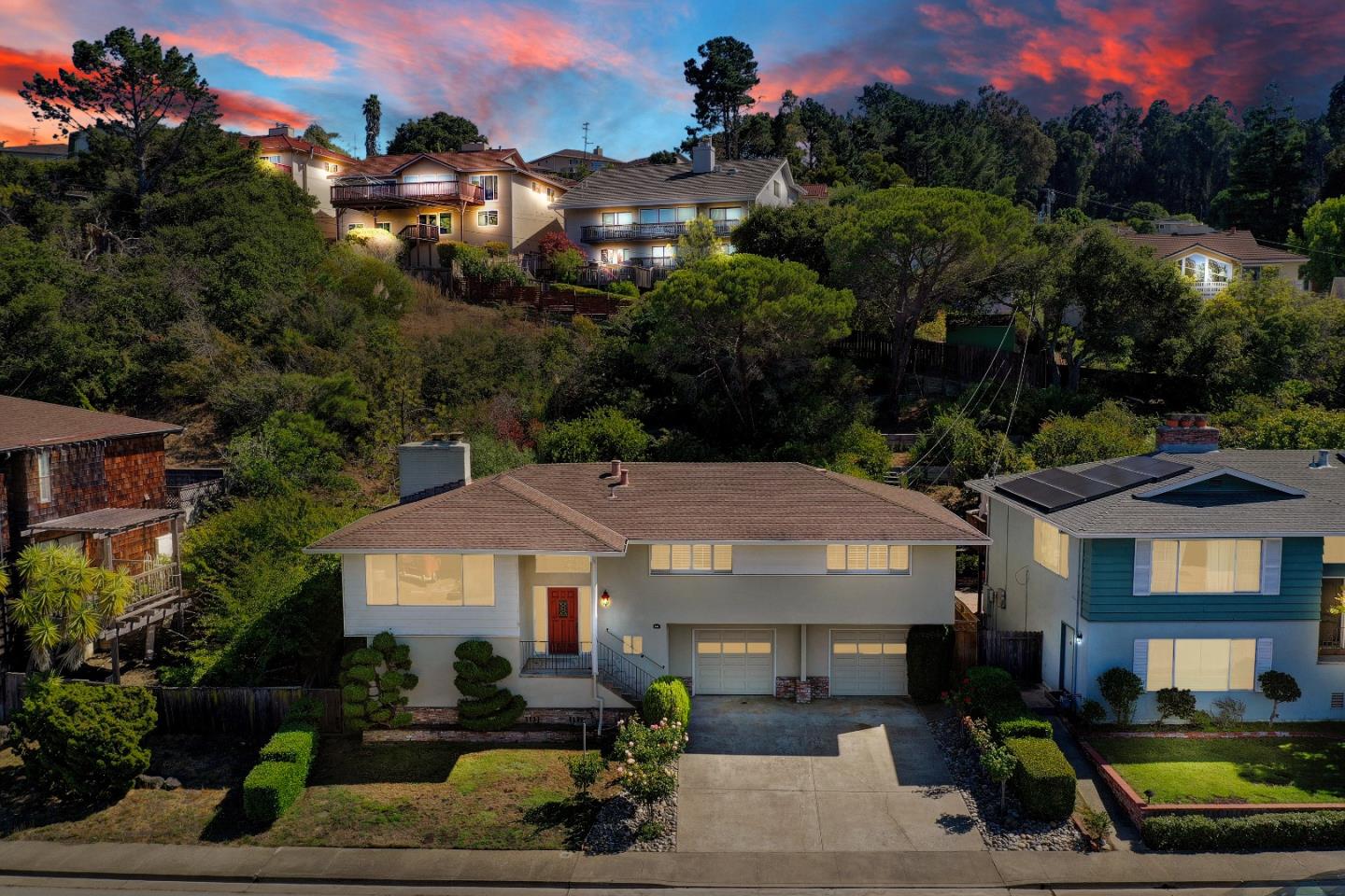 a front view of a house with a garden