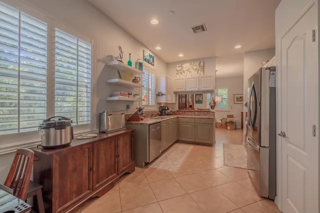a kitchen with stainless steel appliances a refrigerator sink and cabinets