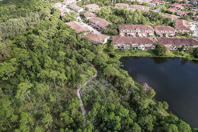 an aerial view of lake and residential houses with outdoor space