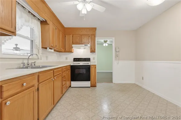 a kitchen with stainless steel appliances a sink stove and cabinets