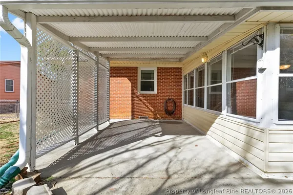 a view of a porch with furniture and floor to ceiling window