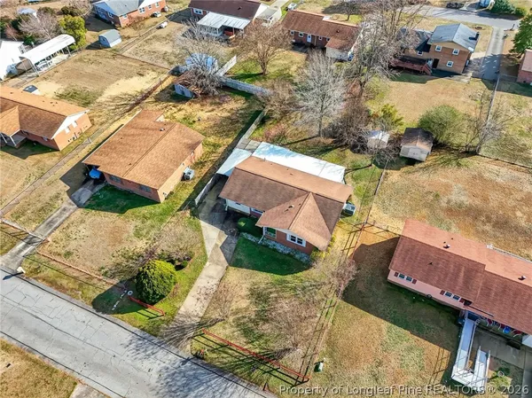 an aerial view of a house with a yard