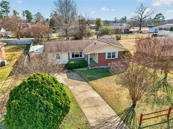 a view of a house next to a yard and lake view