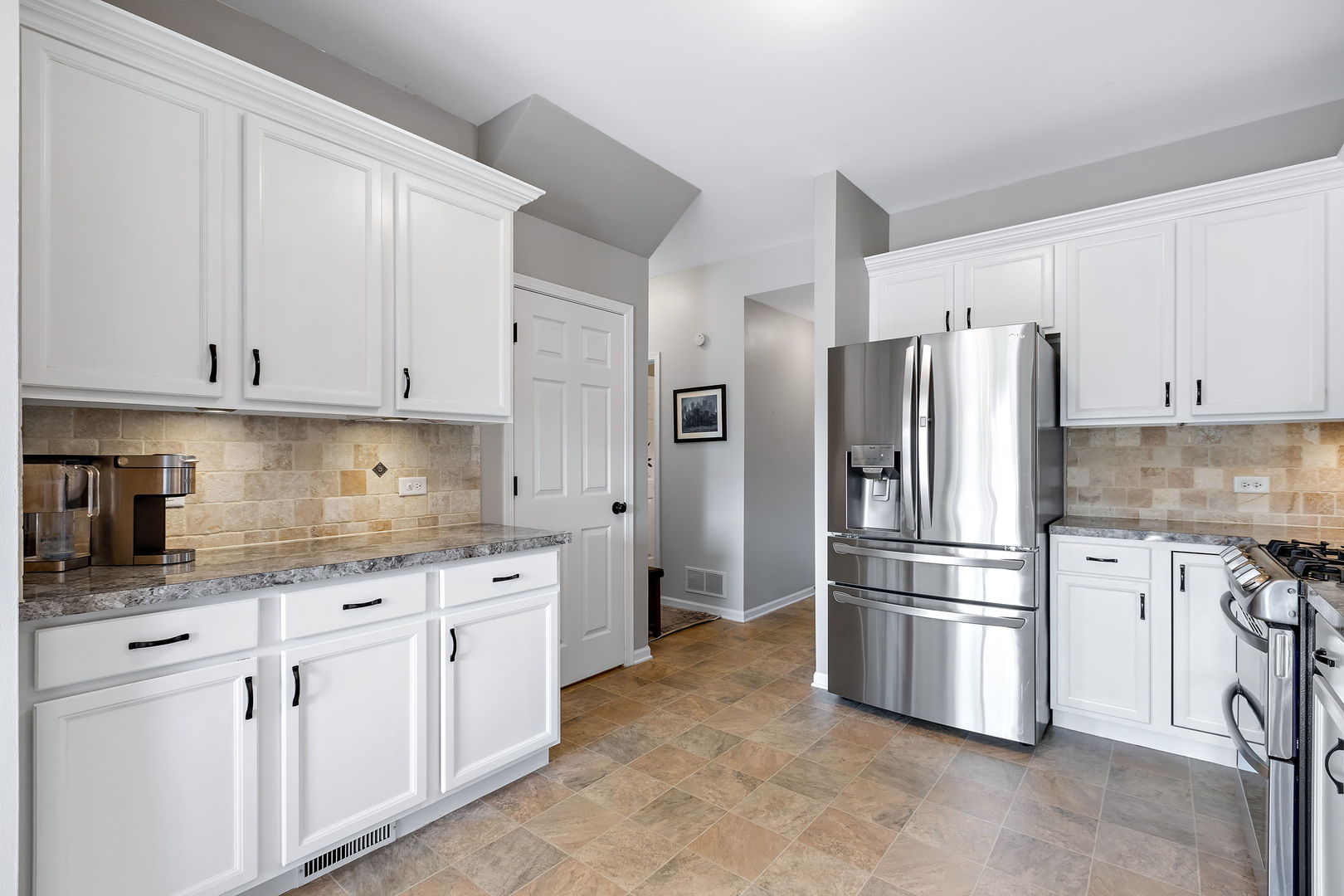 954 Oak Ridge Boulevard Elgin, IL 60120 - Photo 8 of 17 a kitchen with white cabinets and stainless steel appliances