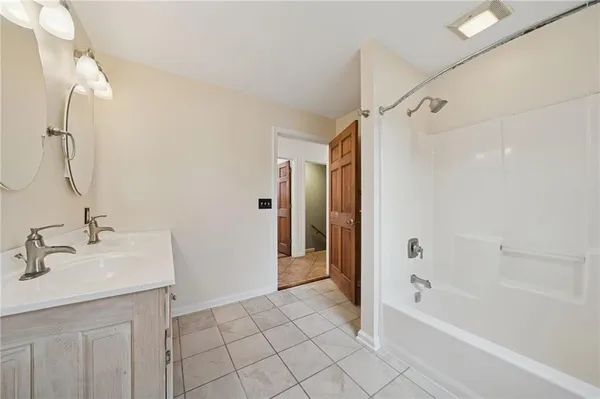 a bathroom with a bath tub and a sink