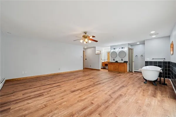 a room with a bed and wooden floor