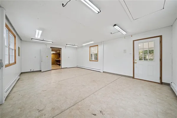 an empty room with windows and closet