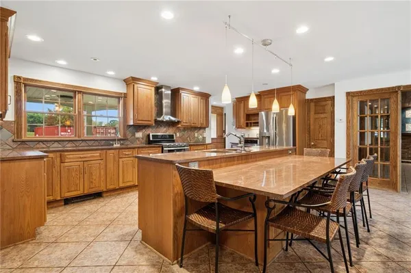 a large kitchen with a table and chairs