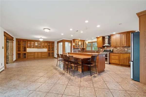 a kitchen with a dining table chairs and large window