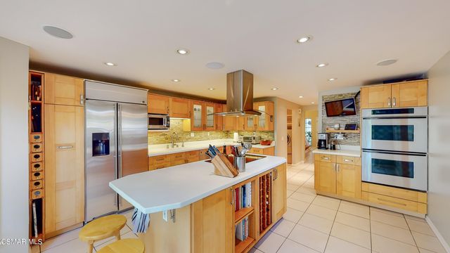 a kitchen with stainless steel appliances granite countertop a sink and a refrigerator