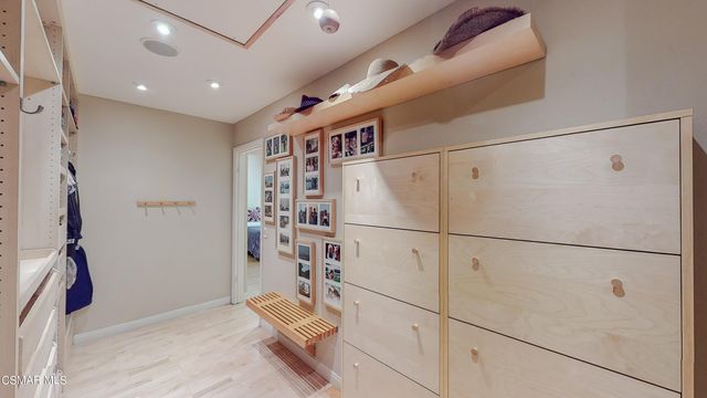 a living room with furniture kitchen view and a large window