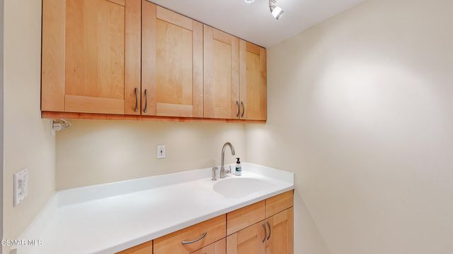an outdoor sitting area with furniture and wooden floor