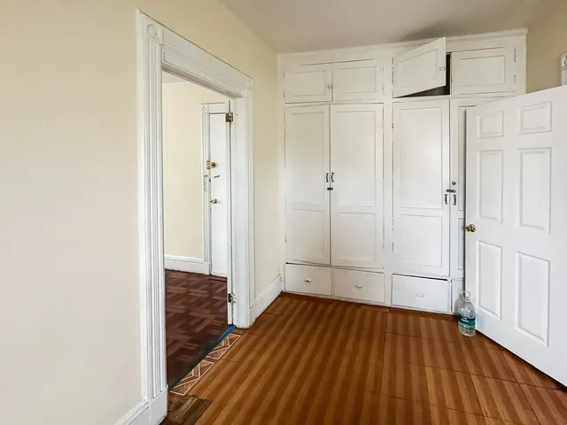 a view of a room with wooden floor