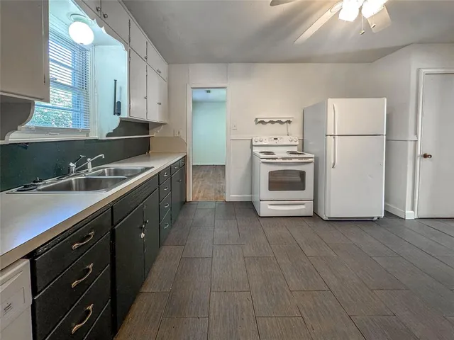 a kitchen with a sink cabinets and stainless steel appliances