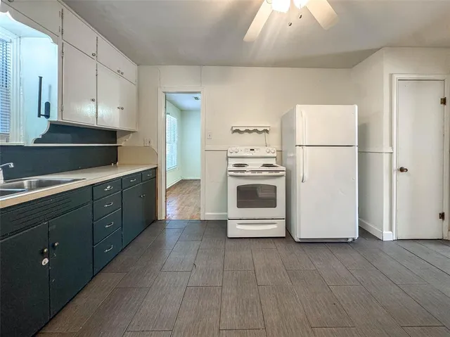 a kitchen with stainless steel appliances a refrigerator sink and cabinets