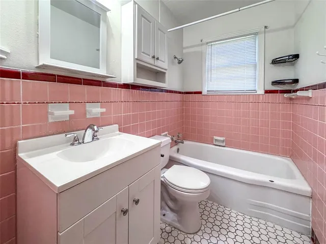 a bathroom with a sink a toilet and a bathtub