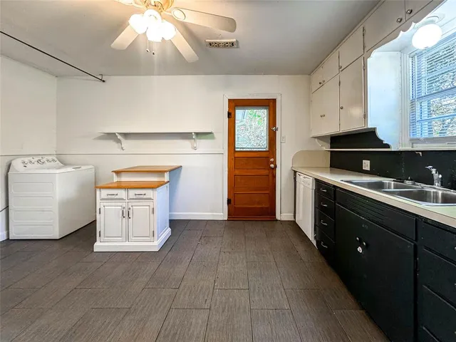 a kitchen with a stove top oven and cabinets