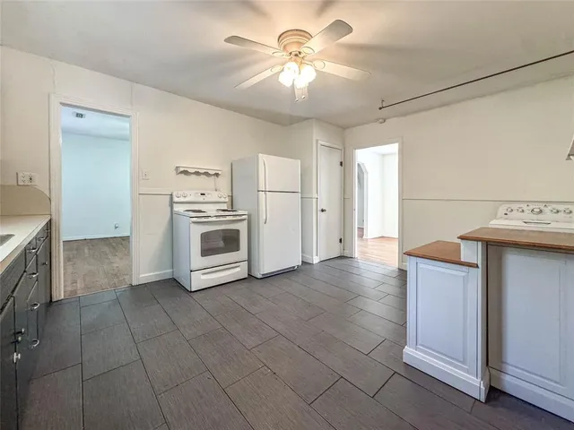 a view of a kitchen with a stove cabinets and a ceiling fan