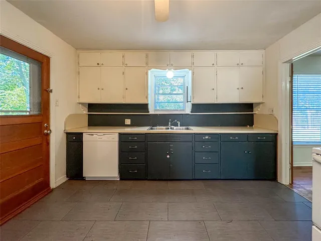 a kitchen with granite countertop a sink and a stove