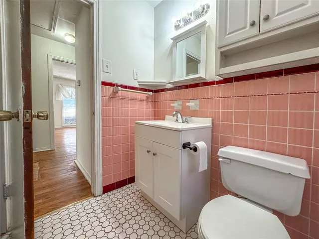 a white toilet sitting next to a bathroom sink