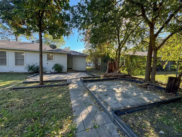 a backyard of a house with barbeque oven